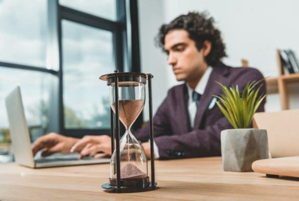 selective focus of businessman typing on laptop while struggling to meet deadlines